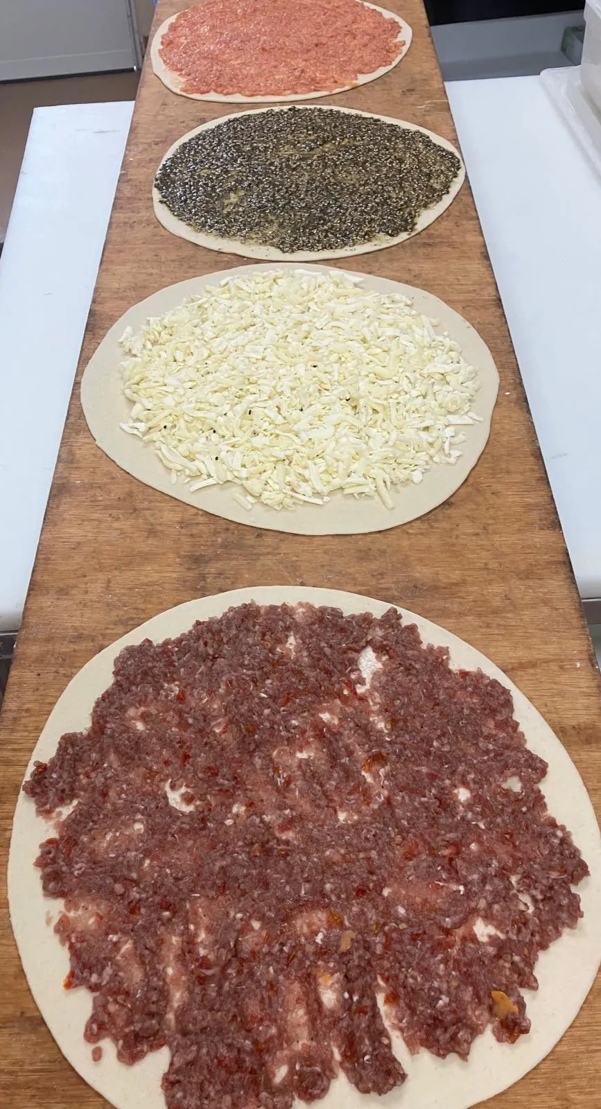 Multiple manoushe being prepared fresh at Adonis Market