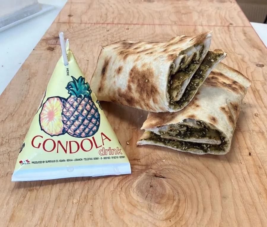 Wrapped zaatar manoushe with juice at Adonis Market